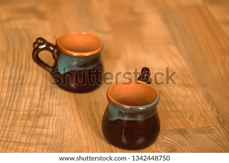 Bruan Ceramic cups on wooden background