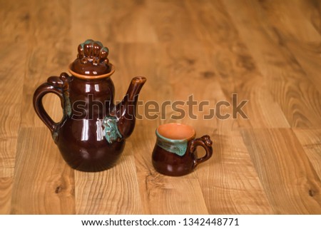 Ceramic teapot and cup with copyspace