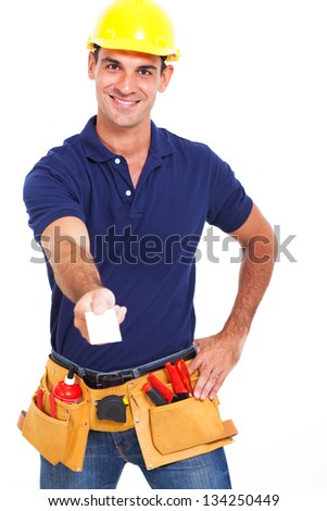 handsome handyman handing over his business card over white background