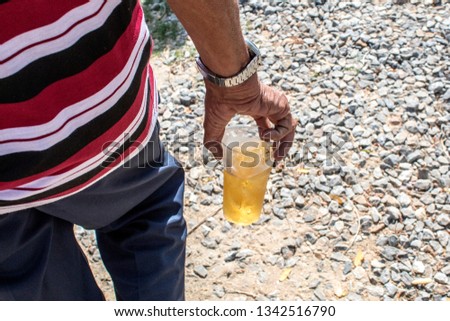 A man walked in the hand with a beer.