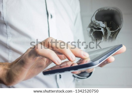 man hand tablet with brain