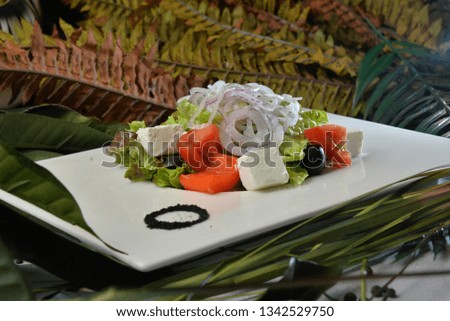 Fresh Greek salad, vegetable salad with feta cheese decorated background - Image