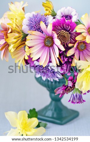 Beautiful bouquet of spring flowers in a vase on the table. Lovely bunch of flowers .Many beautiful fresh flowers on a table. 