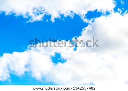 Photo of a blue Sunny sky with white clouds.