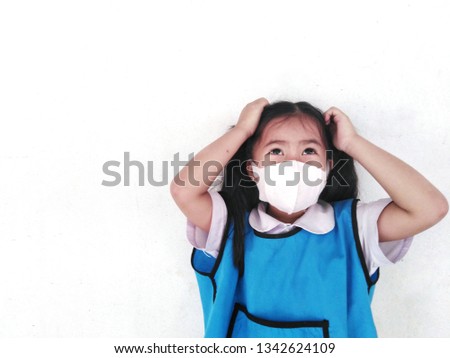 Girl in the medical mask. On a white background, in a blue school uniform