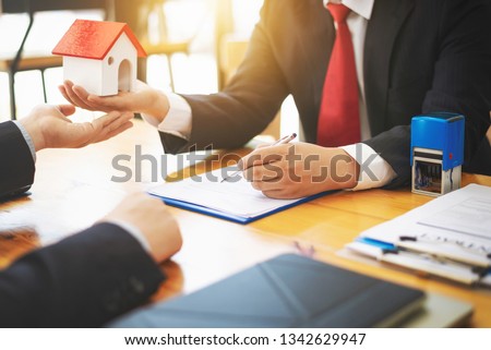 House real estate sell agent reviews the documents that have been approved for the home buyer loan.