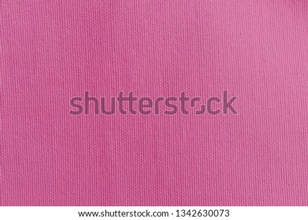 Canvas fabric texture background in pink color.
