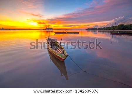 Lonely boat parking with beautiful light of sunset. This photo take in the one of beautiful place Batam island Indonesia.