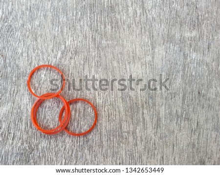 Plastic band red color on wooden board 