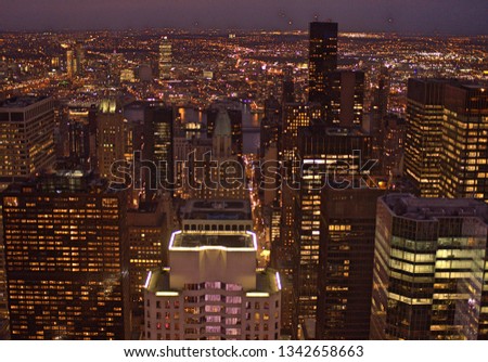 Cityscape of Manhattan building skyline illuminated at night with high-rise and low-rise buildings and skyscrapers 