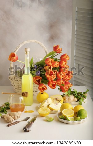 Bottle of homemade juice with ginger and lemon on light background. Vertical Royalty-Free Stock Photo #1342685630