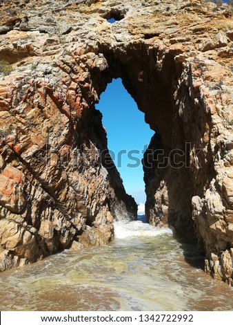 "Arch rock" on Keurbooms beach, near Plettenberg Bay, South Africa.  This is a popular tourist attraction. 