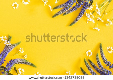 Flowers composition. Chamomile flowers on yellow background. Spring, summer concept. Flat lay, top view, copy space