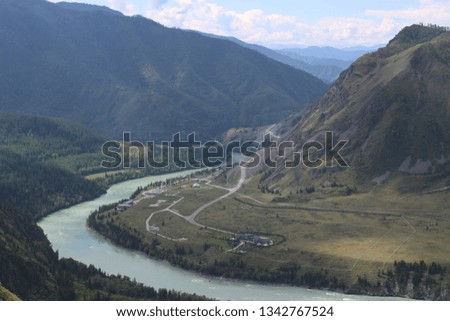 Incredibly beautiful landscape overlooking the turquoise Katun River and the Altai Mountains. The greatness and purity of the Siberian nature