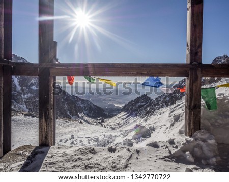 The day view of Small Cold Valley (Mala Studená Dolina) and prayer flags  captured from Teryho Hut (Téryho Chata) in cold snowy winter time. High Tatras, Slovakia. Royalty-Free Stock Photo #1342770722