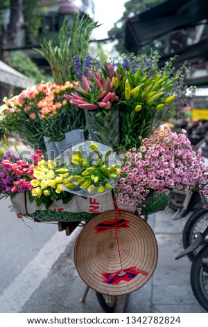 Street vendor selling various types of flowers from their bicycle in Hanoi Old Quarter