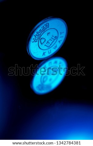 Blue Light Fifty Fils Coin From The State Of Kuwait And It's Reflection Royalty-Free Stock Photo #1342784381