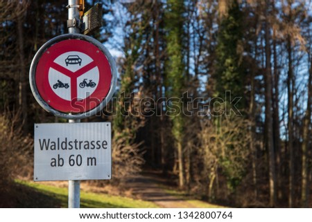 Traffic sign at the beginning of the hiking trail from Forch to Meilen in Switzerland close to the lake of Zurich. All vehicles are prohibited from going into the forest.