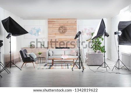 Professional photo studio equipment prepared for shooting living room interior Royalty-Free Stock Photo #1342819622