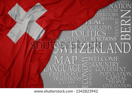 waving colorful national flag of switzerland on a gray background with important words about country . concept
