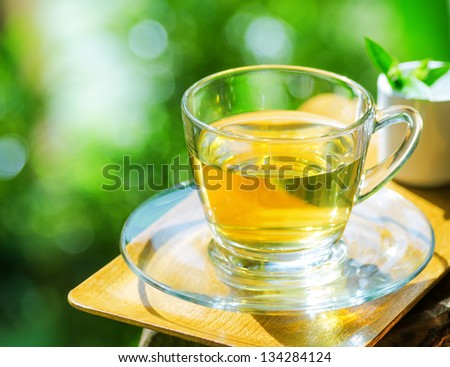 Cup of tea on nature background.