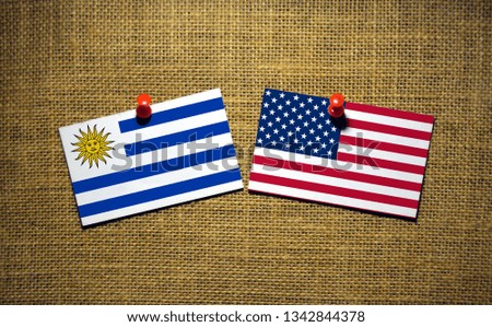 USA and Uruguay flag on sackcloth Background