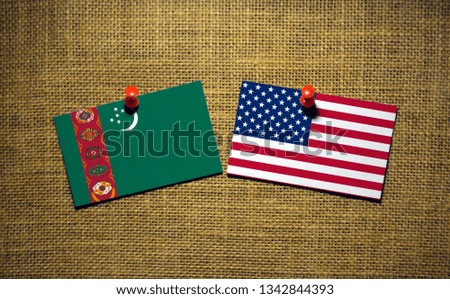 USA and Turkmenistan flag on sackcloth Background