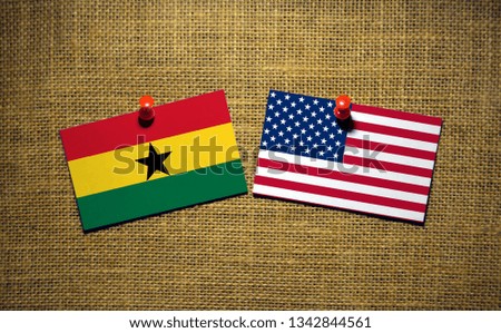 USA and Ghana flag on sackcloth Background