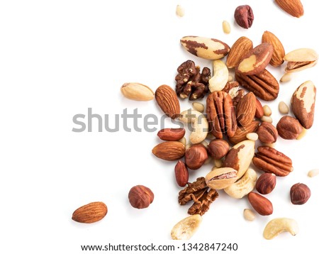 Background of nuts - pecan, macadamia, brazil nut, walnut, almonds, hazelnuts, pistachios, cashews, peanuts, pine nuts.Copy space. Isolated one edge on white with clipping path. Top view or flat lay Royalty-Free Stock Photo #1342847240