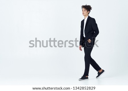 man in shoes in a classic suit with curly hair on his head                        