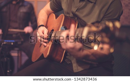 The artist plays the guitar. Rock band at a concert Royalty-Free Stock Photo #1342873436