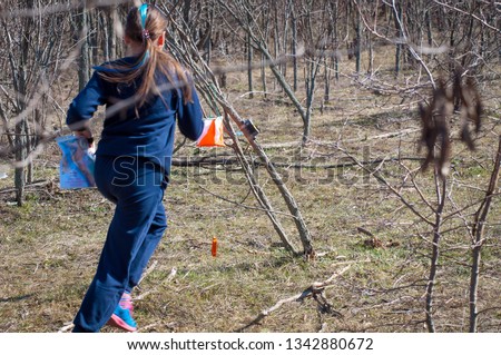 Orienteering. Check point Prism and electronic composter for orienteering. Athlete teenager girl approaching the control point Royalty-Free Stock Photo #1342880672