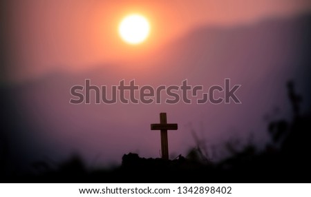 The cross standing with light sunset background. christian silhouette concept