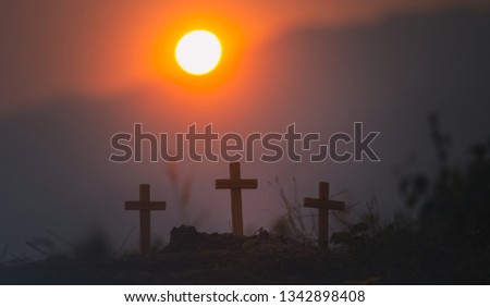 three wooden cross of christian standing with light sunset background. christian silhouette concept