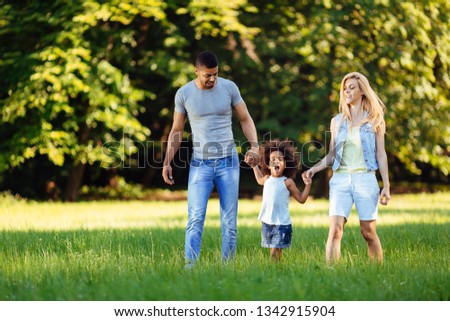 Happy young couple spending time with their daughter