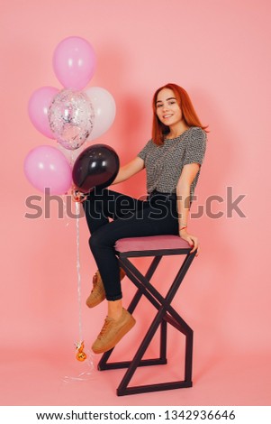 young and stylish girls in a studio with colored balls