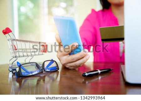 Businesswomen holding cedit card on mobile for shopping online.concept