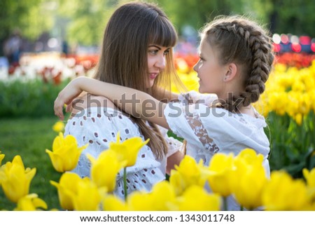 Happy mom and daughter hug each other