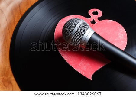 Song for lovers. Nostalgic songs, concept with vinyl records, microphone and heart Royalty-Free Stock Photo #1343026067