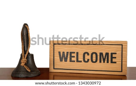 welcome sign,A wooden sign "Welcome" on a wooden table in the shop
