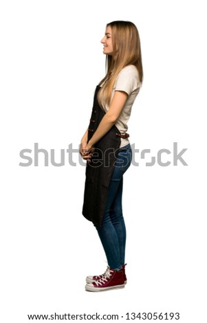 Full body Young woman with apron in lateral position on isolated background