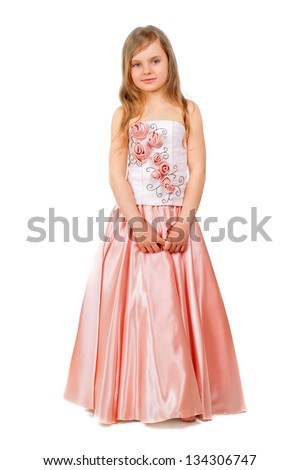Beautiful little girl wearing nice peach dress. Isolated on white