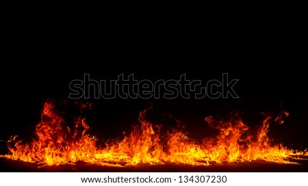 Blazing flames over black background