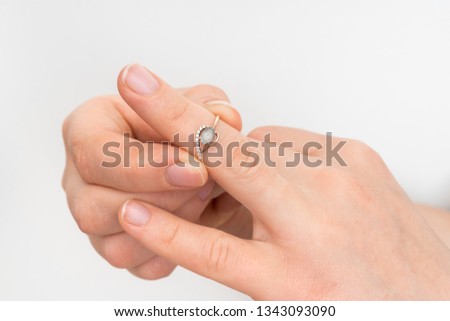 Woman take off wedding ring - divorce concept