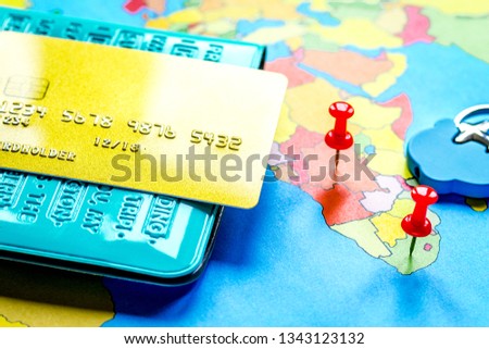 Traveling concept with passport and credit card on map