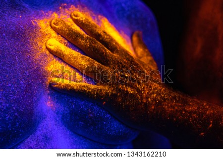 Black light with neon paint, hand, shine
