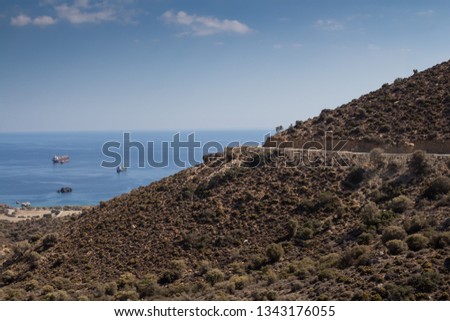 Coast of the south Crete with its hills. View on the Mediterranean sea with its horizon. Blue autumn sky. South of Crete, Greece.