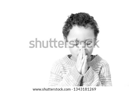 boy praying to God with hands held together and head bowed low on white background stock image and stock photo