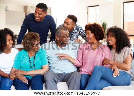 Happy multi generation black family relaxing together at home Royalty-Free Stock Photo #1343195999