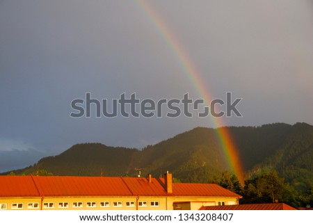 Rainbow over small city which is situated in the middle of woods/forest. Liptovský Hrádok, Slovakia. 